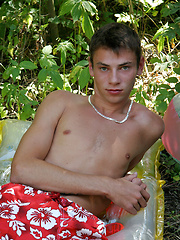 These four tanned twinks have found a quiet corner in the bushes and are busy sucking cock